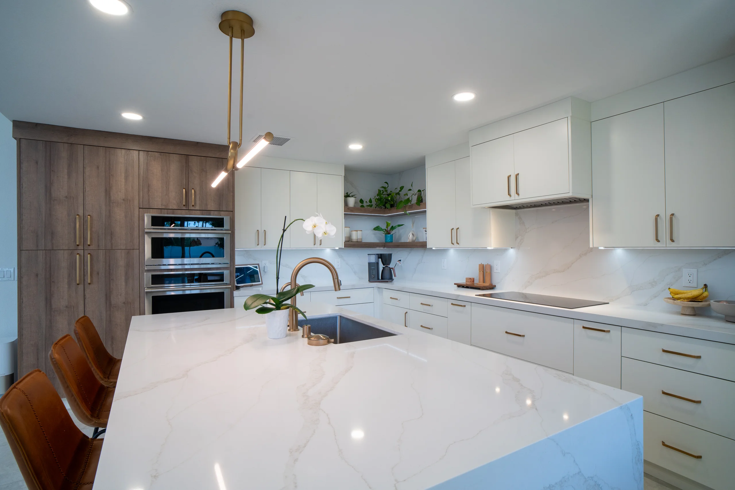 Large kitchen island with waterfall quartz
