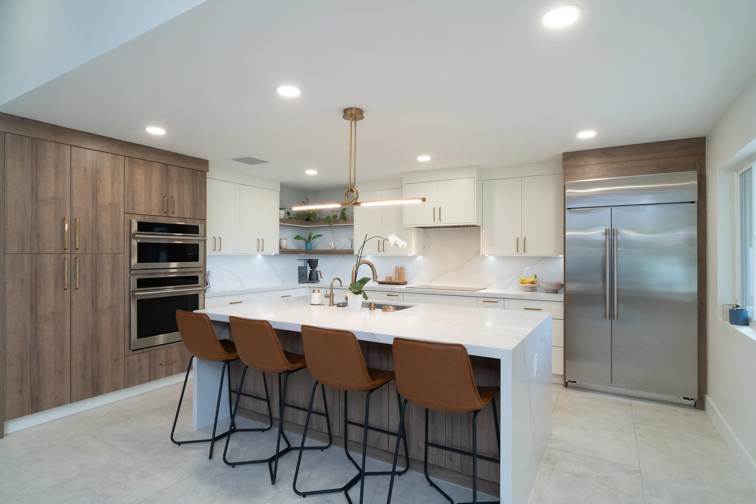 Kitchen overview with white cabinets and brass accents