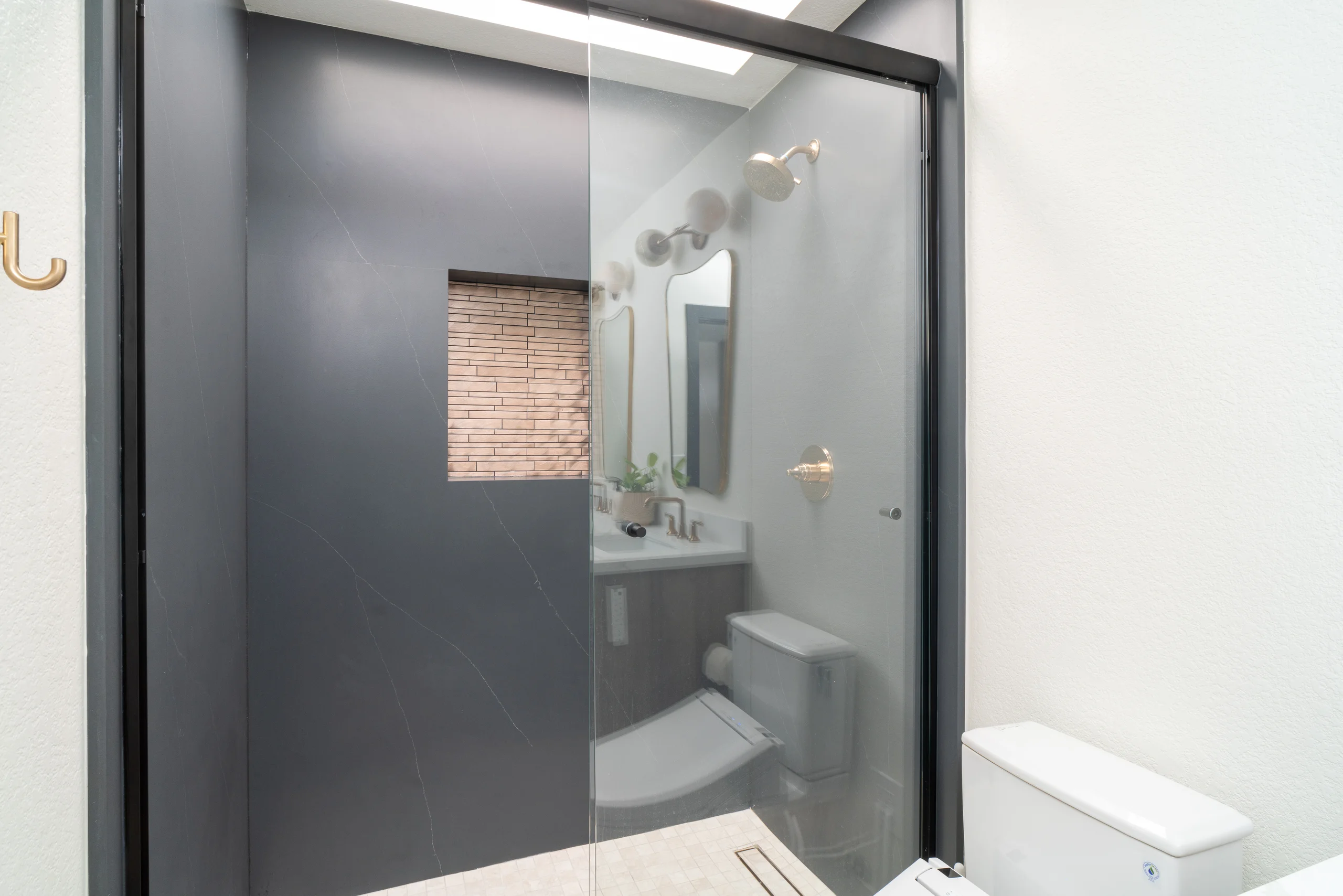 Secondary bathroom walk-in shower with dark tile