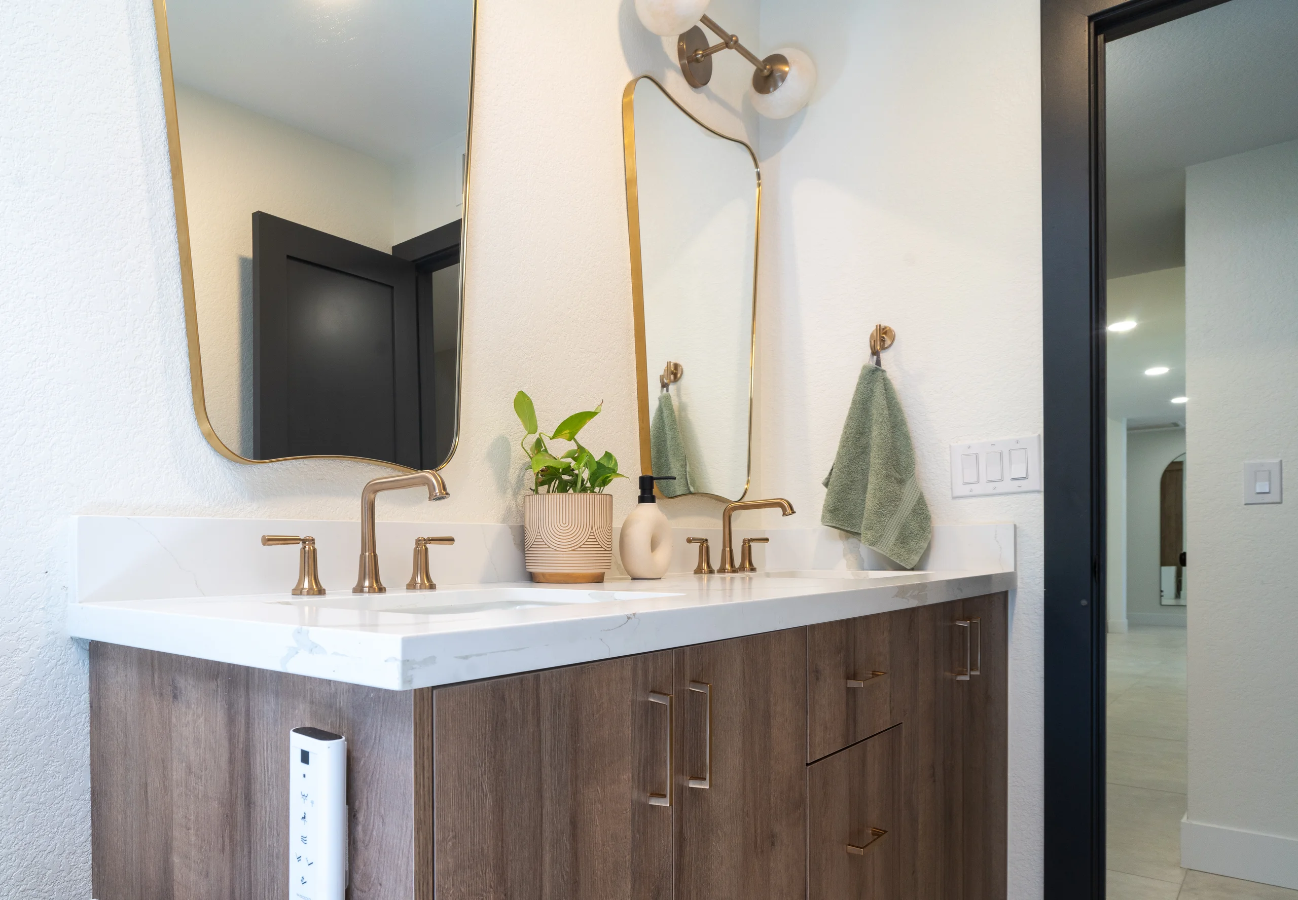 Secondary bathroom vanity with brass lighting