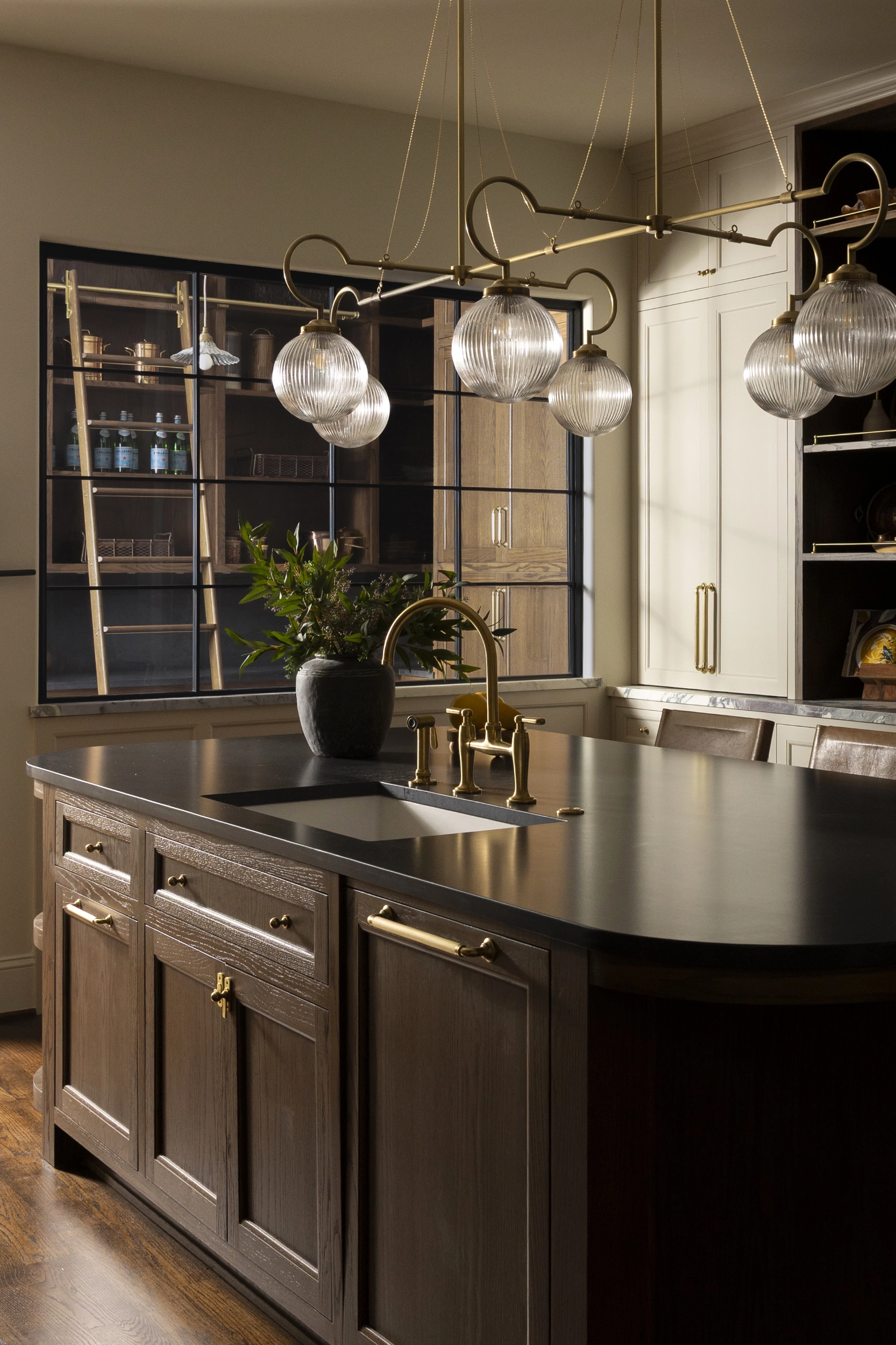 Statement kitchen island with black quartz countertop and integrated sink