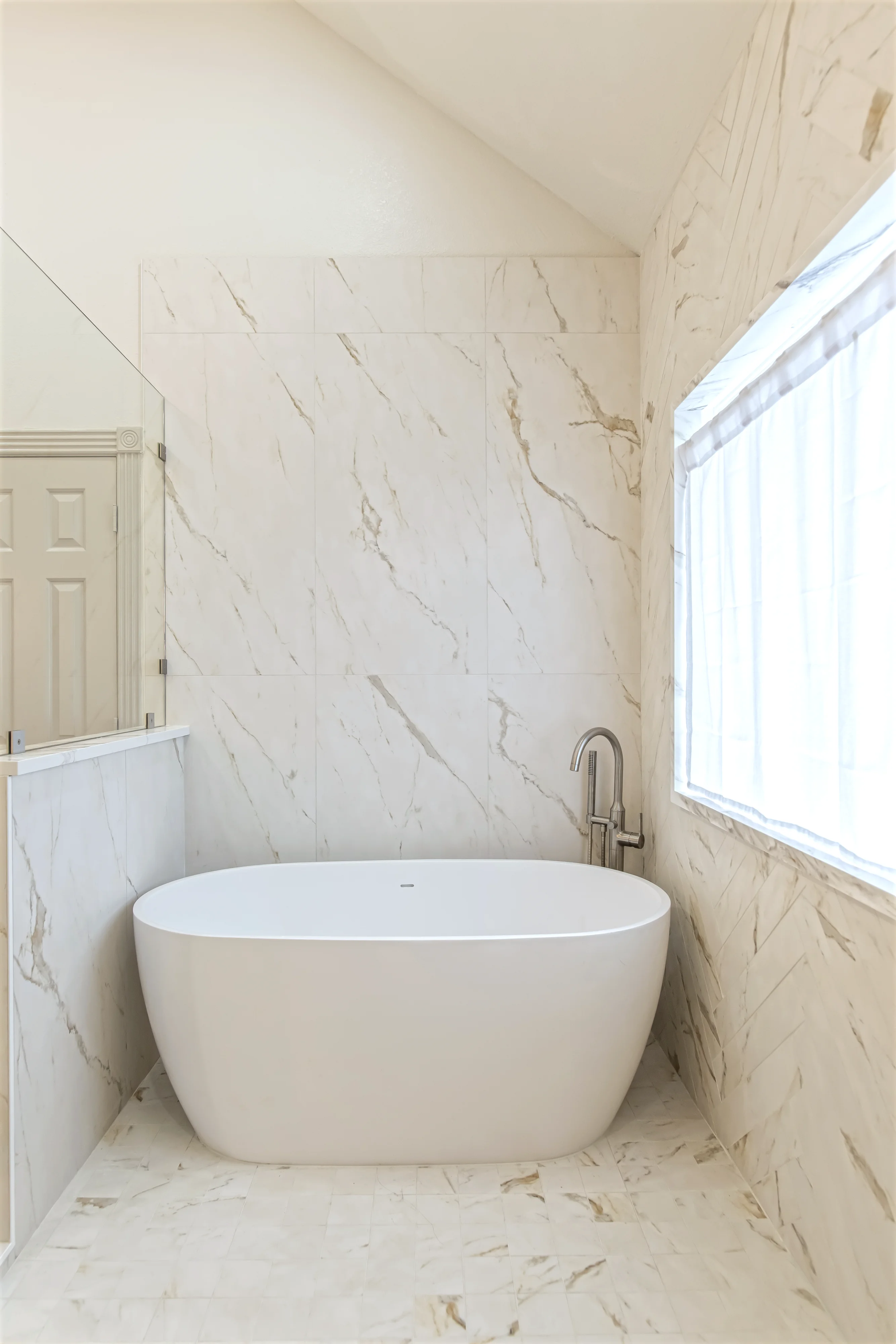Primary bathroom freestanding tub in a wetroom